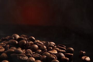 coffee beans on a dark background with a red highlight on the background, coffee beans close-up for a coffee shop