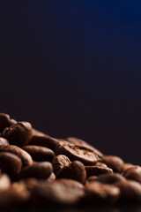 coffee beans on a dark background with a blue highlight on the background