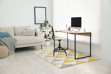 Stylish workplace with wooden desk, stationery and computer at home office. Interior design