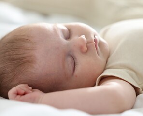 Cute newborn baby sleeping on bed indoors