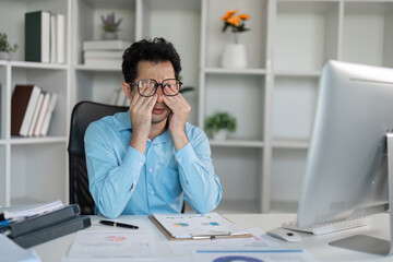 Tired professional overcomes hard work challenges at office desk detailed analysis business...