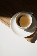 Espresso on Wooden Board in Contrast Daylight. Coffee Brew.	                            