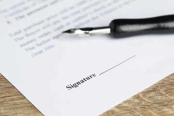 Notary document and fountain pen on wooden table, selective focus