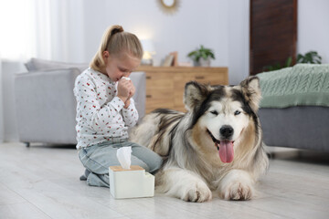 Girl suffering from allergy with her dog at home