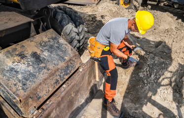Construction Worker Performing Excavation Work at a Job Site During Daylight Hours