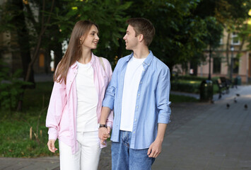 Lovely couple walking together on city street