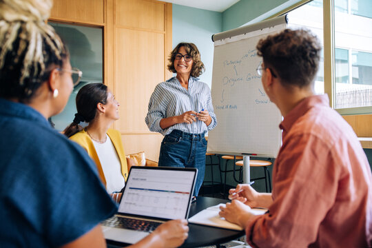 Business team in a meeting discussing strategies and ideas in a modern office