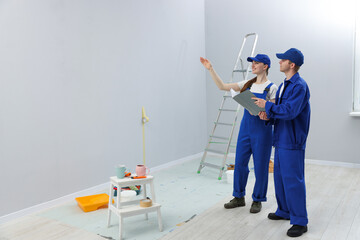 Workers looking at design project in room. Space for text