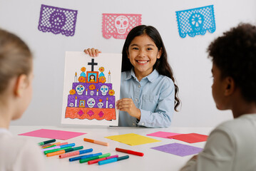 smiling latina girl presenting colorful day of the dead drawing in art class with classmates and papel picado decorations in background