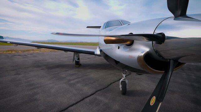 Close-up view of engine and propeller of Pilatus PC 12 luxury jet on tarmac