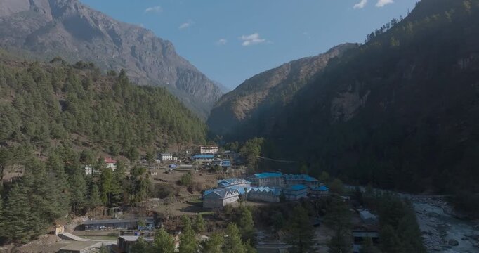 Namche village aerial view on Everest trail shows lush green Sagarmatha hills, clear sky, snowless peaks&mdash;a reminder of global warming impact at Gateway to Everest