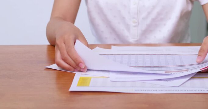 Organizing important documents on a desk home office paperwork professional close-up productivity