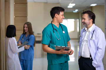 Senior doctor is discussing and brainstorming with young nurse on patient medical record after...