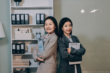 Entrepreneur Asian businessman and businesswoman discussing new business project in tablet in...