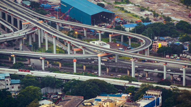 Aerial cinematic image of Mumbai during the monsoon season, featuring dramatic clouds over the city skyline. Atal Setu sea bridge in Mumbai, Maharashtra, India.