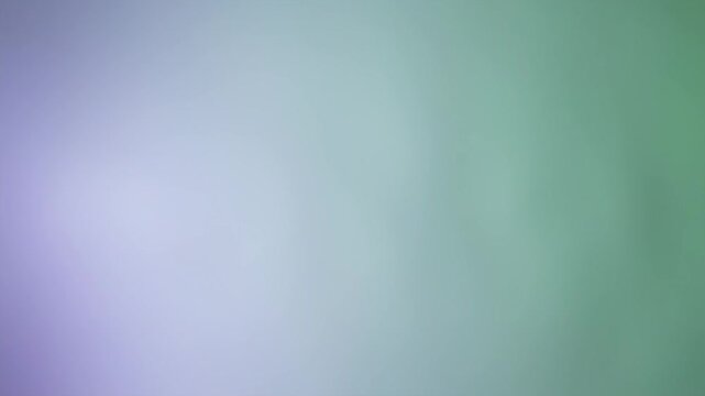 Soft, blurred gradient of lavender melding into cool, hazy green hues in a smooth transition