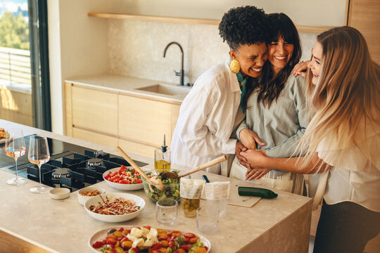 A woman joyfully shares her pregnancy announcement with her close friends