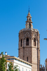 El Micalet tower stands tall against a clear blue sky in Valencia, showcasing its intricate Gothic architecture and symbolizing the city's rich history.