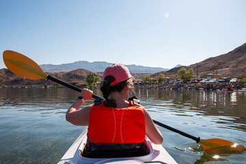 Enjoying a Peaceful Kayak Trip on a Clear Lake in the Afternoon Sun