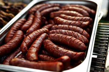 Close-up of grilled sausages in large tray