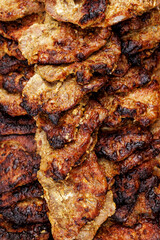 Grilled pork meat slices stacked in tray