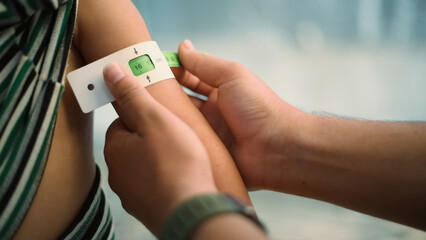 A doctor examines children's malnutrition inside a refugee camp. Malnutrition was measured using a mid-upper arm circumference belt.
