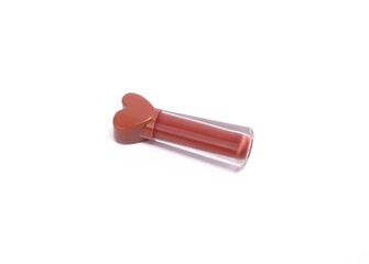 A tube of reddish-brown liquid lipstick with a heart-shaped cap, in a clear cylindrical tube.