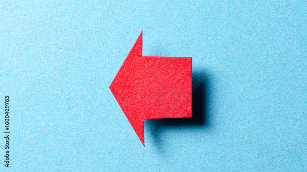 Poster Red blank paper cardboard arrow direction sign with shadow and copy space for text on blue background, flat lay top view pointing symbol conceptual message backdrop