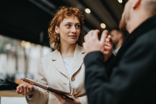 Two entrepreneurs engage in a meaningful discussion outdoors, exchanging innovative ideas and strategies.