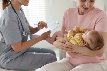 Mother and her cute baby having appointment with pediatrician in hospital, closeup