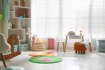 Stylish playroom with toys and furniture. Interior design