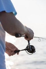 fisherman fishing, Fishing rod, spinning, fisherman against blue sky