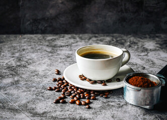 ground coffee in Portafilter and beans with coffee cup ,Top view Espresso coffee cup aromatic and making equipment
