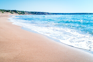 Blue sea waves on the famous sandy beach. Lara Beach, Peyia near Paphos, Cyprus.