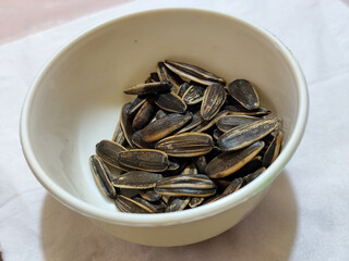 Roasted sunflower seeds in black and white striped shells, ready to be enjoyed as a healthy snack.