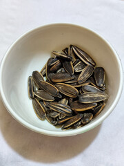 Roasted sunflower seeds in black and white striped shells, ready to be enjoyed as a healthy snack.