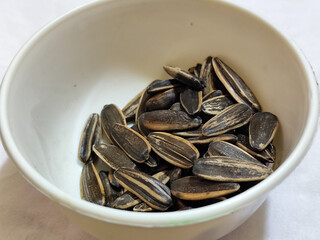 Roasted sunflower seeds in black and white striped shells, ready to be enjoyed as a healthy snack.