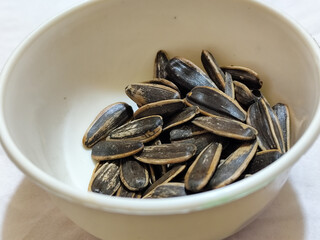 Roasted sunflower seeds in black and white striped shells, ready to be enjoyed as a healthy snack.