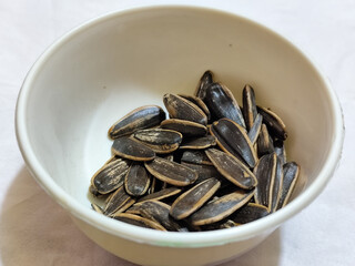 Roasted sunflower seeds in black and white striped shells, ready to be enjoyed as a healthy snack.