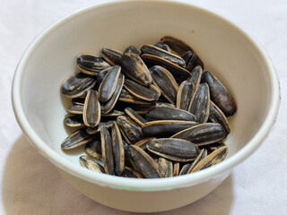 Roasted sunflower seeds in black and white striped shells, ready to be enjoyed as a healthy snack.