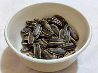 Roasted sunflower seeds in black and white striped shells, ready to be enjoyed as a healthy snack.