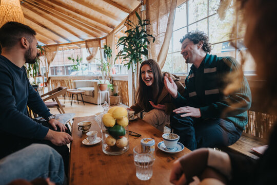 A group of young friends enjoying a lively conversation and coffee together in a beautifully decorated cafe. The environment exudes warmth and happiness, emphasizing bond and shared moments.