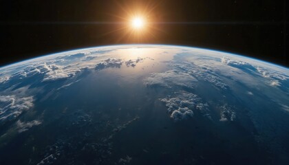 Stunning view of Earth from space as sun rises, casting golden rays over clouds and oceans. Witness our planet atmosphere curving against blackness of universe. Global perspective, new day begins.