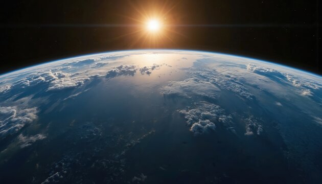 Stunning view of Earth from space as sun rises, casting golden rays over clouds and oceans. Witness our planet atmosphere curving against blackness of universe. Global perspective, new day begins.