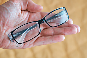 Close up of glasses in hand
