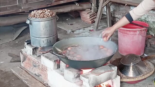 The process of making Indonesian boiled pindang eggs cooked with spices and leaves gives it a unique color and taste, especially when cooked using a wood-fired cooking stove.