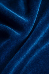 Obraz premium Close-up of textured deep blue velvet fabric draped elegantly