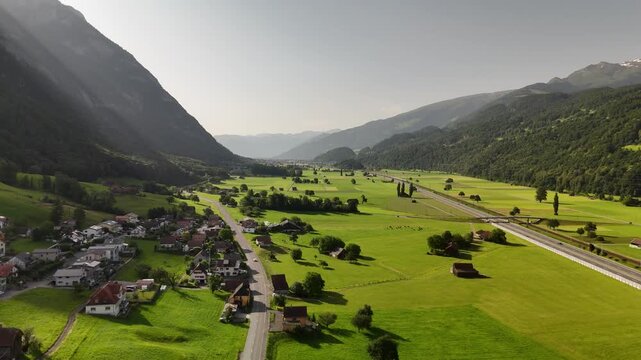 Scenic Aerial View of a Valley with Green Fields and Mountain Landscape in Switzerland near Flums, Berschis, and Walenstadt in the Canton of St. Gallen &ndash; Drone Footage