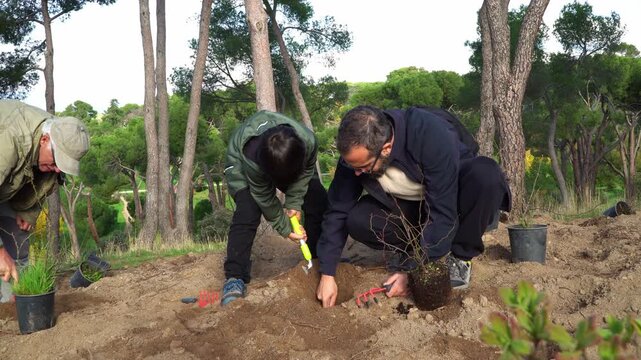 Family collaborating together on an environmental community reforestation