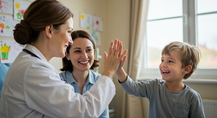 Obraz premium Pediatrician high-fives happy child with mother present in brightly lit examination room